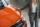 woman-standing-near-orange-colored-car-and-touchin-2023-11-27-05-00-23-utc