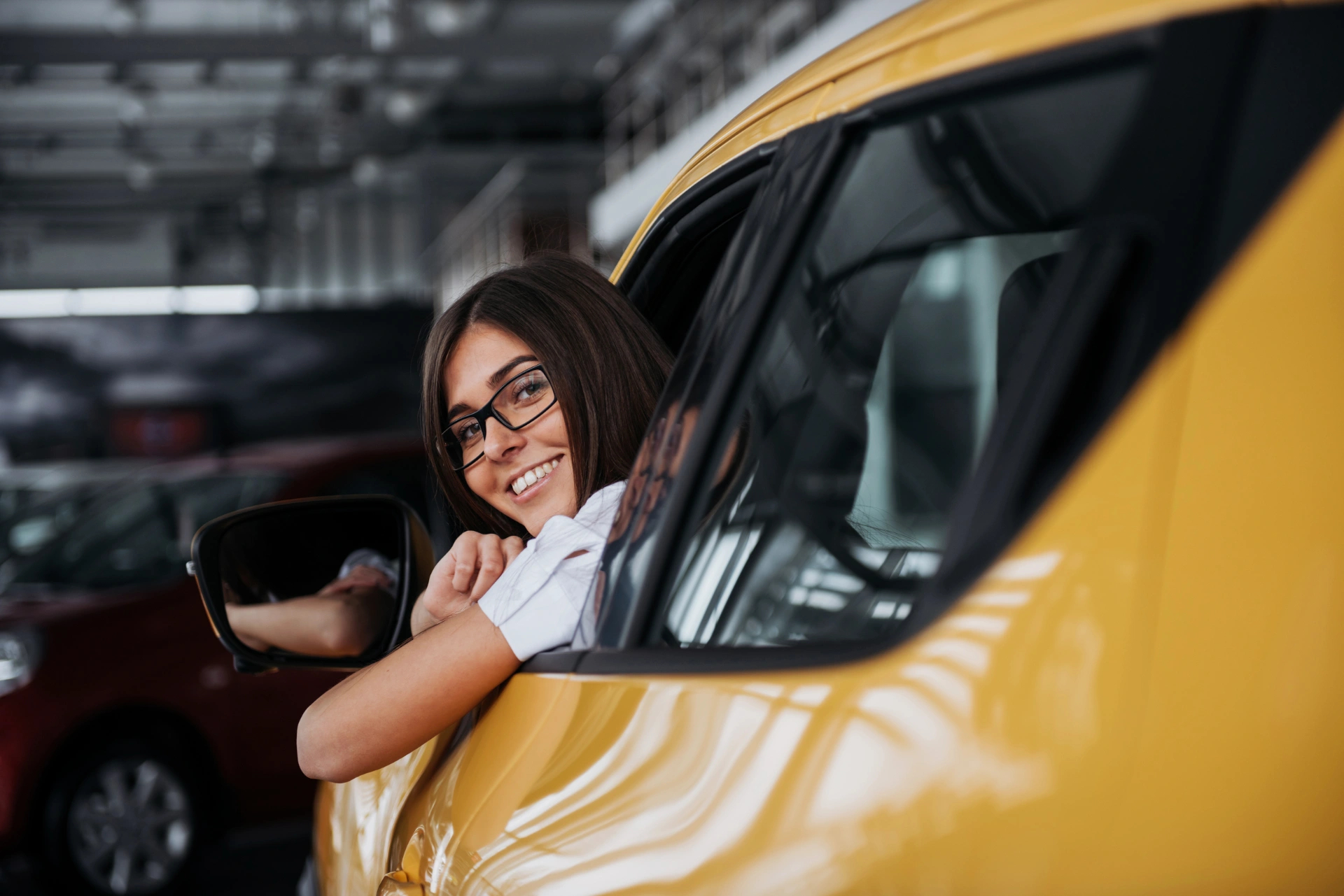 young-woman-in-her-new-car-smiling-2023-11-27-05-21-38-utc